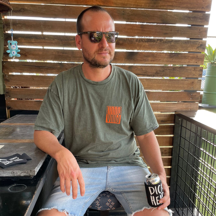 Man at bar with Dickhead stubby holder 
